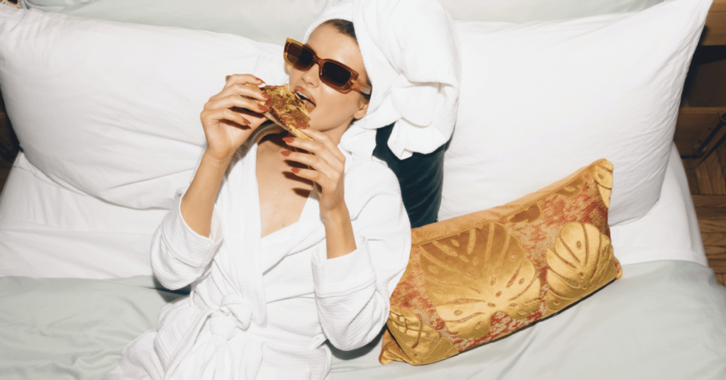 guerrilla marketing ideas, a woman sits in a robe eating pizza, looking fabulous and relaxed