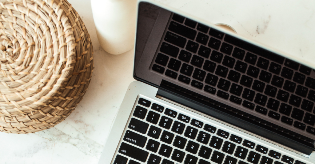 a laptop in an aesthetic scene website homepage must haves featured image