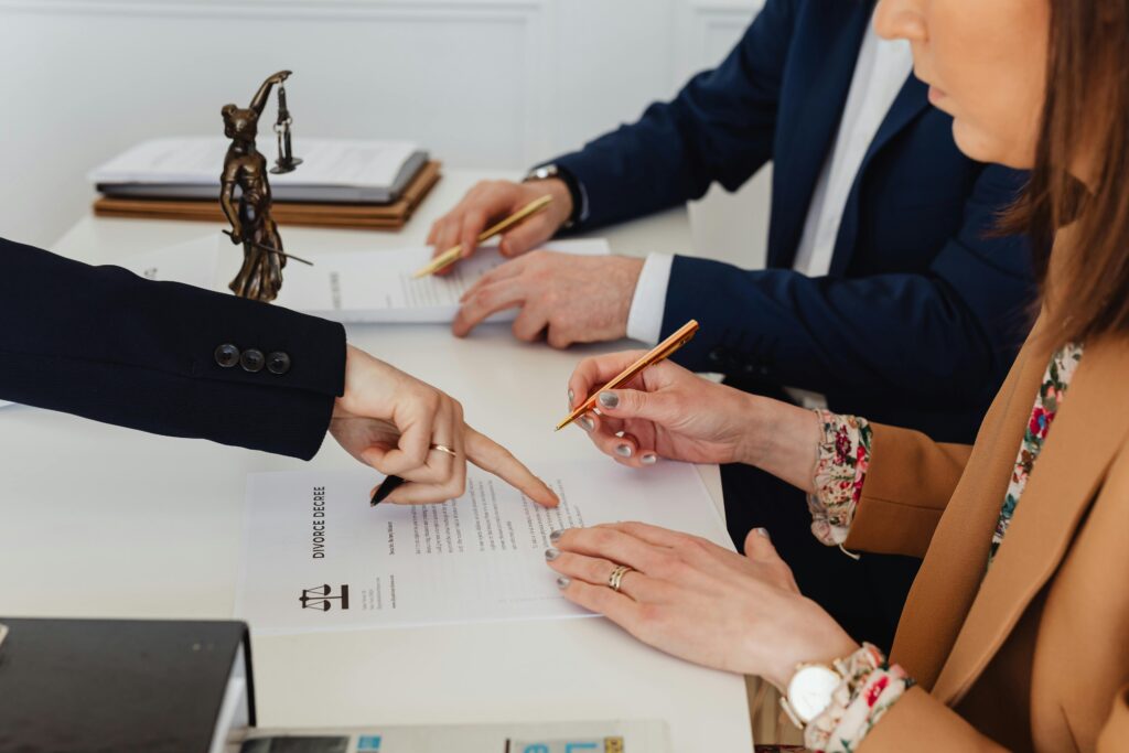 Boutique law firm team reviewing a client intake form and legal documents during an initial client consultation.